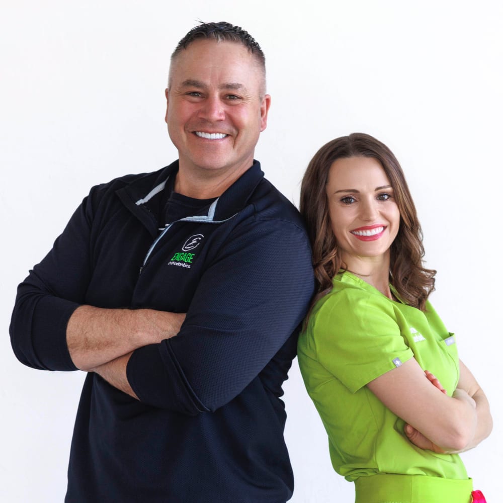Green Bay orthodontists Dr. Mark Hanson and Dr. Melanie Hammerbeck standing back to back.